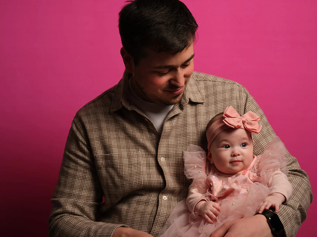 High-end father and baby portraiture using the Kaleid mobile studio setup, showing the connection between parent and child in a professional, at-home studio environment.